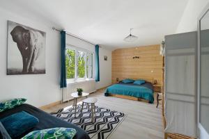 a bedroom with a bed and a couch and a table at Gîte De L'etrie in Mauves-sur-Loire