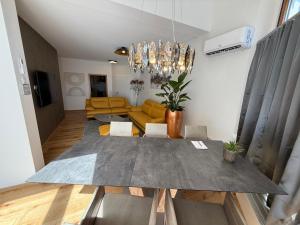 a living room with a table and a couch at Residence Loft in Friedrichshafen