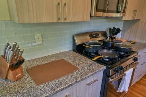 a kitchen with a stove with pots and pans on it at Cozy Huguenot Hideaway in Huguenot