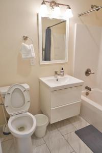 a bathroom with a toilet and a sink and a mirror at Cozy Huguenot Hideaway in Huguenot