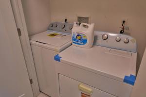 a small kitchen with a white washer at Cozy Huguenot Hideaway in Huguenot +12 photos