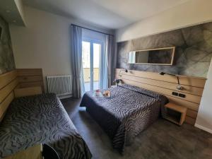 a hotel room with a bed and a window at Albergo Suisse Bellevue in Monterosso al Mare
