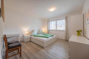 a living room with a couch and a window at Haus am Bach in Fulpmes