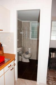 a bathroom with a toilet and a sink at Arcadia Coastal Studio by ΜΡS in Xiropigado