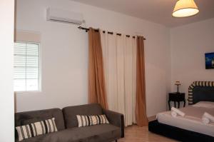 a living room with a couch and a window at Arcadia Coastal Studio by ΜΡS in Xiropigado