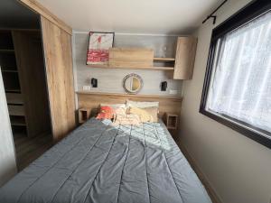 a bed in a small room with a window at La Cabane in Claouey +11 photos
