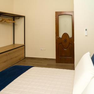 a bedroom with a bed and a wooden door at Prima Classe Battipaglia in Battipaglia