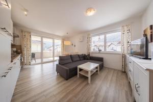 a living room with a couch and a table at Haus am Bach in Fulpmes