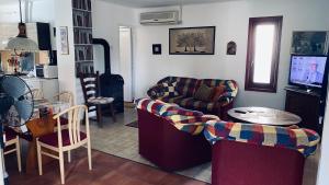 a living room with a couch and a table at FLY Vendégház in Szólád