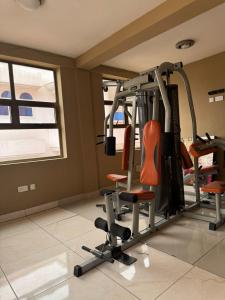a room with a gym with two tread machines at 247Hotel Apartments in Accra