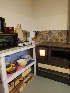 a kitchen with an oven with a bunch of dishes at Blaues Häuschen in Gössendorf +12 photos