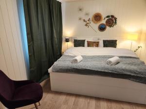 a bedroom with a bed and a chair in it at Gate 1 apartment in Måløy