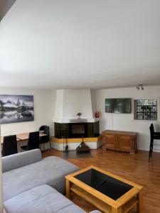 a living room with a couch and a table at Garden House Interlaken in Interlaken