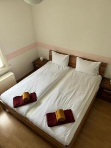 a large white bed with two pillows on it at Garden House Interlaken in Interlaken +4 photos