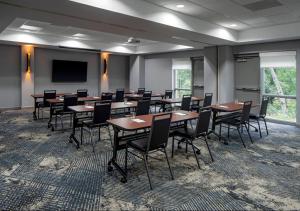 a conference room with tables and chairs and a screen at Hyatt Place Fair Lawn Paramus in Fair Lawn +16 photos