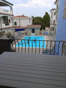 a view of a swimming pool from a balcony at Little paradise apartment with pool in Orosei