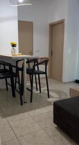 a table and a bench in a room at Diktamo Coast Living in Ofrínion