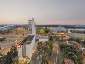 an aerial view of a city with a tall building at Novotel Sydney Olympic Park in Sydney