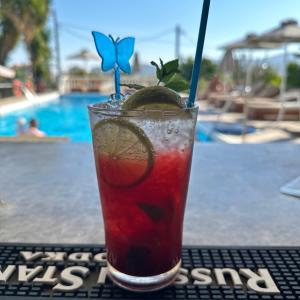 a drink sitting on a table next to a pool at Anthis Studios in Pythagoreio