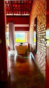 a bathroom with a bath tub and a window at Solar do Ouro in São Thomé das Letras +20 photos