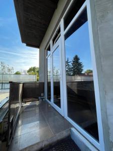 a balcony with sliding glass doors on a building at Vivat in Berehove