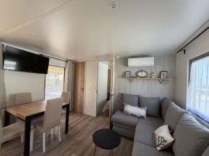 a living room with a couch and a table at La Cabane in Claouey