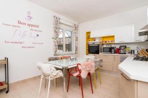 a kitchen with a table and chairs in a room at Tudor Central House Sibiu - Garden, Parking, Quiet Area in Sibiu