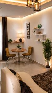a living room with a table and chairs at Skyline Residence Apartment in Douala in Douala