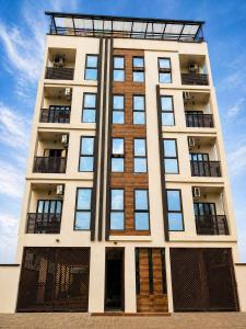 a tall building with many windows on the side at Skyline Residence Apartment in Douala in Douala