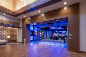 a lobby of a casino with a sign on the wall at Golden Mesa Hotel in Guymon