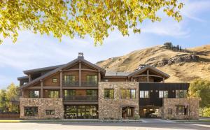 a large house with a mountain in the background at The Rusty Parrot Lodge and Spa in Jackson