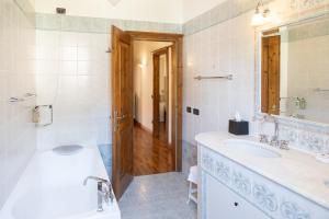 a bathroom with a sink and a toilet and a mirror at Appartamenti Apollo XI, GTSGroup in Tignale +13 photos