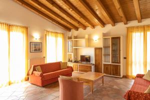 a living room with a couch and a table at Appartamenti Apollo XI, GTSGroup in Tignale