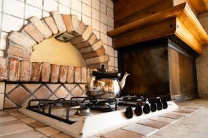 a tea kettle on top of a stove in a kitchen at Appartamenti Apollo XI, GTSGroup in Tignale