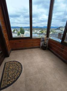 a room with a large window with a view at Mountain, espectacular departamento con vista súper funcional in Ushuaia