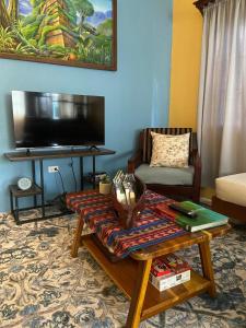 a living room with a coffee table and a tv at Casa Maruka in San Ignacio