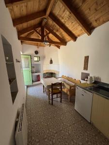 a kitchen and living room with a table and a couch at To Ampeli in Potamós