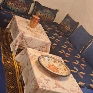 a plate sitting on top of a bed with pillows at Casa de campo in Al Hoceïma
