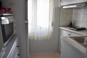 a small kitchen with a sink and a window at Castle View in Samothraki