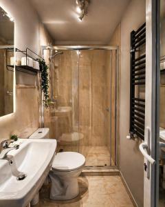 a bathroom with a shower and a toilet and a sink at Pensiunea Relax in Curtea de Argeş +135 photos