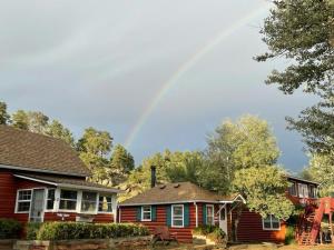 a rainbow in the sky above a house at Colorado Cottages in Estes Park