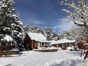 a house covered in snow in a yard at Colorado Cottages in Estes Park +82 photos