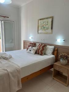 a bedroom with a large bed with two pillows at Antonio Studios in Alikanas