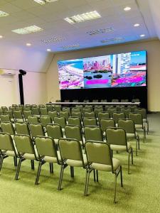 a conference room with chairs and a large screen at Hotel Vila Inglesa in Campos do Jordão +185 photos