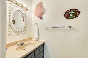 a bathroom with a sink and a mirror at Beachfront - Private Walkover to Beach in Surfside Beach
