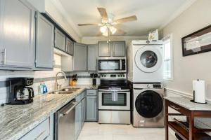 a kitchen with a stove and a washer and dryer at Beachfront - Private Walkover to Beach in Surfside Beach