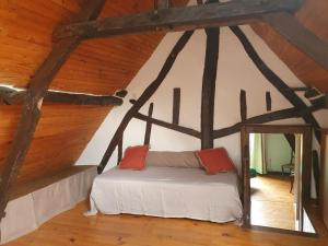 a room with a bed in a attic at Longère 'Nature et Baies' in Montigny +27 photos