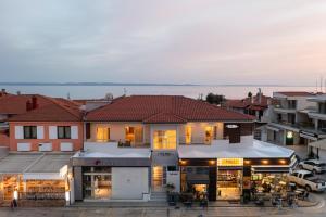 a building with a restaurant in the middle of a city at The Mall Luxury Suites in Nikiti