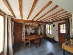 a dining room with a wooden table and chairs at Longère 'Nature et Baies' in Montigny
