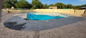 a swimming pool in the middle of a patio at Mobile home style maisonnette de vacance in Méjannes-le-Clap